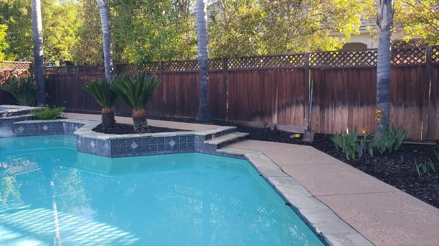 Board fence around a backyard pool